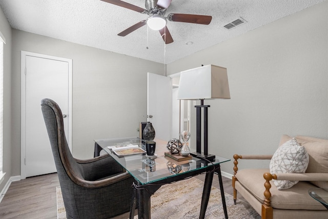 220 Timber Ridge Ln, Coppell, TX 75019 - home office featuring light wood-style flooring, a textured ceiling, a ceiling fan, and baseboards