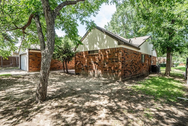 220 Timber Ridge Ln, Coppell, TX 75019 - view of side of home with brick siding, central AC, driveway, and an attached garage