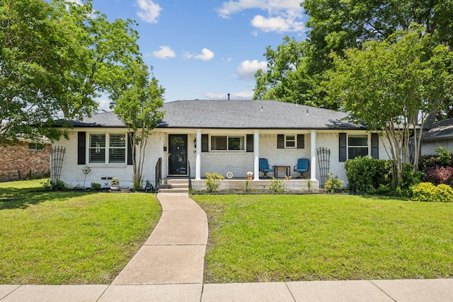 519 E Polk St, Richardson, TX 75081 - view of front of home featuring a front lawn, brick siding, and a porch