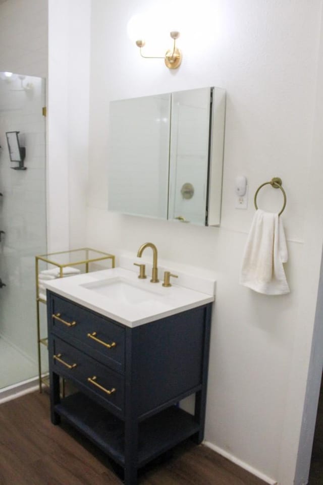 610 W 6th, Cisco, TX 76437 - full bath featuring vanity, wood finished floors, and a shower stall