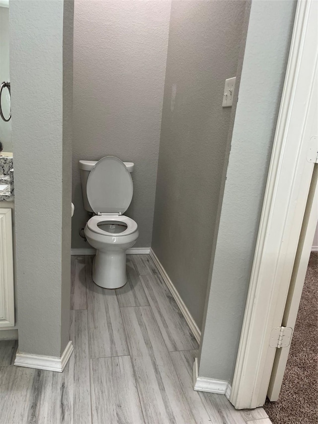 2020 Southwood Trl, Grand Prairie, TX 75052 - bathroom featuring toilet, baseboards, and wood finished floors