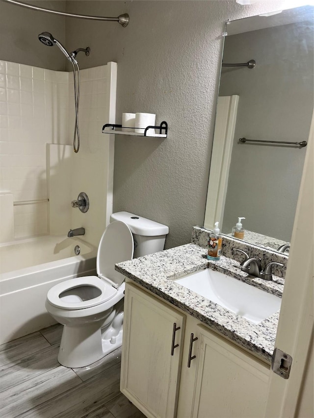 2020 Southwood Trl, Grand Prairie, TX 75052 - full bath with vanity, a textured wall, tub / shower combination, toilet, and wood finished floors