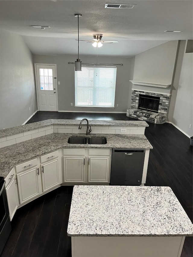 2020 Southwood Trl, Grand Prairie, TX 75052 - kitchen featuring a sink, dishwasher, dark wood finished floors, a ceiling fan, and light stone countertops