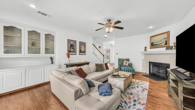 120 Oak Hollow Ct S, Azle, TX 76020 - living room with light wood-style flooring, ceiling fan, stairs, a fireplace with flush hearth, and recessed lighting