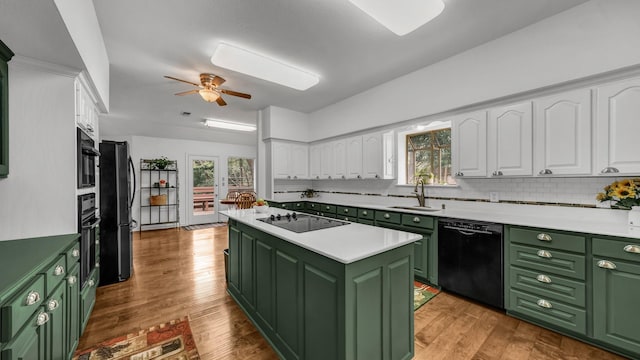 120 Oak Hollow Ct S, Azle, TX 76020 - kitchen featuring green cabinets, black appliances, a sink, and white cabinetry