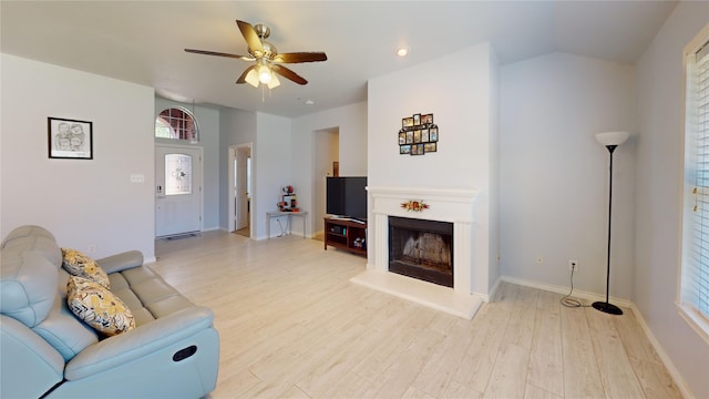 2801 Hereford Rd, Denton, TX 76210 - living room with a ceiling fan, light wood finished floors, a fireplace with raised hearth, and baseboards