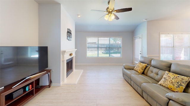 2801 Hereford Rd, Denton, TX 76210 - living room featuring a ceiling fan, baseboards, light wood-type flooring, and a fireplace with raised hearth