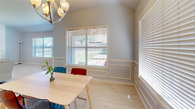 2801 Hereford Rd, Denton, TX 76210 - dining space with a chandelier, a wainscoted wall, light wood-style floors, and a decorative wall