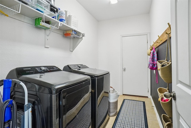 4028 Burwood Dr, Fort Worth, TX 76262 - washroom featuring washing machine and dryer and light tile patterned flooring