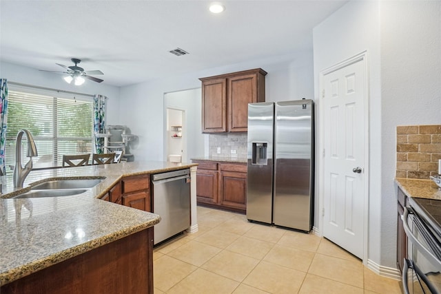 4028 Burwood Dr, Fort Worth, TX 76262 - kitchen with appliances with stainless steel finishes, a sink, backsplash, ceiling fan, and light tile patterned flooring