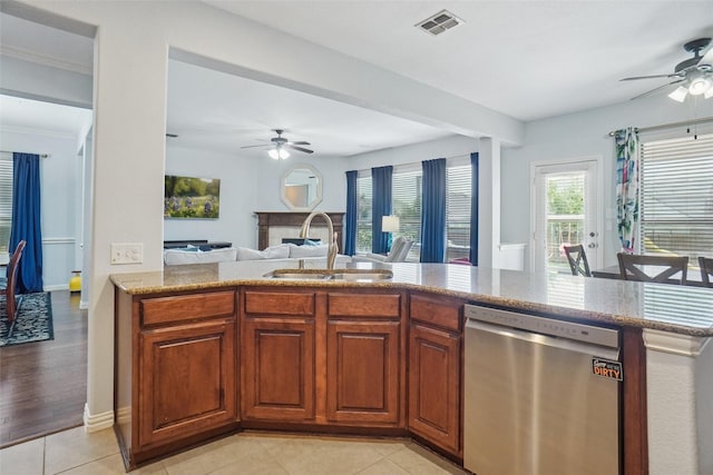 4028 Burwood Dr, Fort Worth, TX 76262 - kitchen with stainless steel dishwasher, ceiling fan, a sink, open floor plan, and light stone countertops