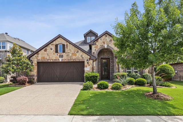 4328 Waterstone Rd, Fort Worth, TX 76244 - view of front facade featuring stone siding, a garage, a front lawn, driveway, and brick siding