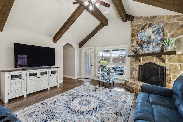 4328 Waterstone Rd, Fort Worth, TX 76244 - living room featuring arched walkways, a stone fireplace, a ceiling fan, dark wood finished floors, and baseboards