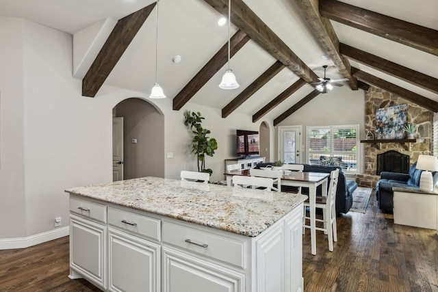 4328 Waterstone Rd, Fort Worth, TX 76244 - kitchen with arched walkways, ceiling fan, dark wood-style flooring, and white cabinets