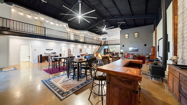 TBD Vz County Road 4418, Canton, TX 75103 - dining room featuring a towering ceiling, concrete flooring, a ceiling fan, and a wood stove