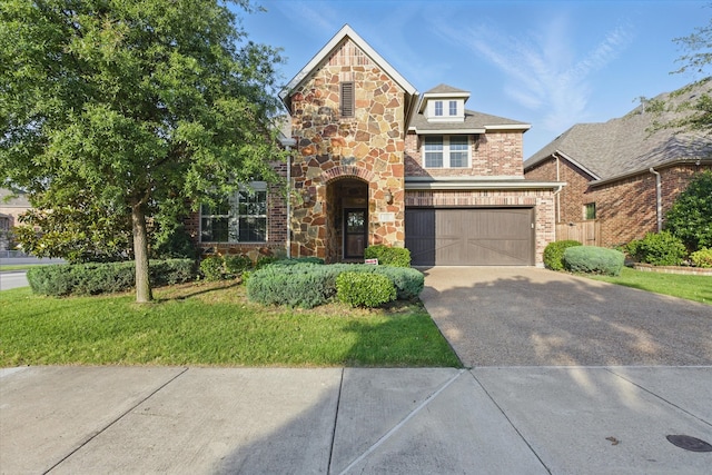 128 Brown Knight Ln, Lewisville, TX 75056 - view of front of house with concrete driveway, a garage, stone siding, and brick siding