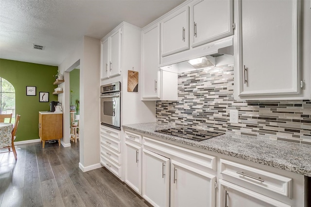 6325 Wallingford Dr, Fort Worth, TX 76133 - kitchen featuring oven, black electric cooktop, white cabinetry, dark wood-type flooring, and a textured ceiling