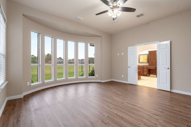 10205 Fairway Vista Dr, Rowlett, TX 75089 - spare room featuring baseboards, light wood-style flooring, and a ceiling fan