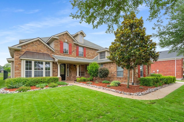 10205 Fairway Vista Dr, Rowlett, TX 75089 - traditional home featuring a front yard, brick siding, and a porch