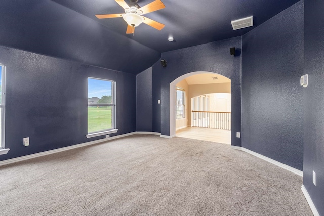 10205 Fairway Vista Dr, Rowlett, TX 75089 - carpeted spare room featuring a textured wall, arched walkways, ceiling fan, lofted ceiling, and baseboards