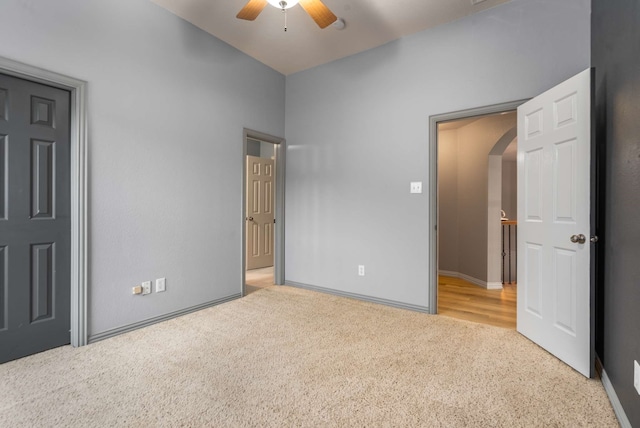 10205 Fairway Vista Dr, Rowlett, TX 75089 - unfurnished bedroom with arched walkways, carpet, baseboards, and a ceiling fan