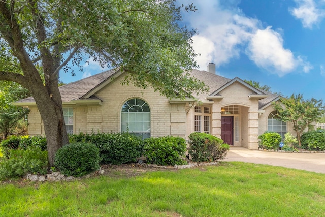 3528 Whitney Way, Hurst, TX 76054 - view of front of home with brick siding, a shingled roof, a front yard, and a chimney
