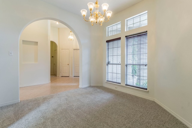 3528 Whitney Way, Hurst, TX 76054 - spare room with a chandelier, arched walkways, light carpet, healthy amount of natural light, and a towering ceiling