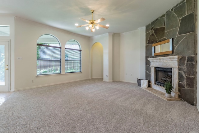3528 Whitney Way, Hurst, TX 76054 - unfurnished living room featuring a ceiling fan, crown molding, a fireplace, carpet flooring, and arched walkways