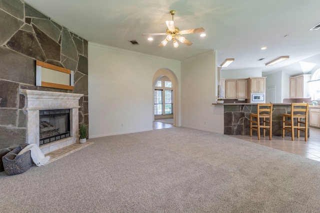 3528 Whitney Way, Hurst, TX 76054 - living room with ornamental molding, baseboards, light colored carpet, ceiling fan, and arched walkways