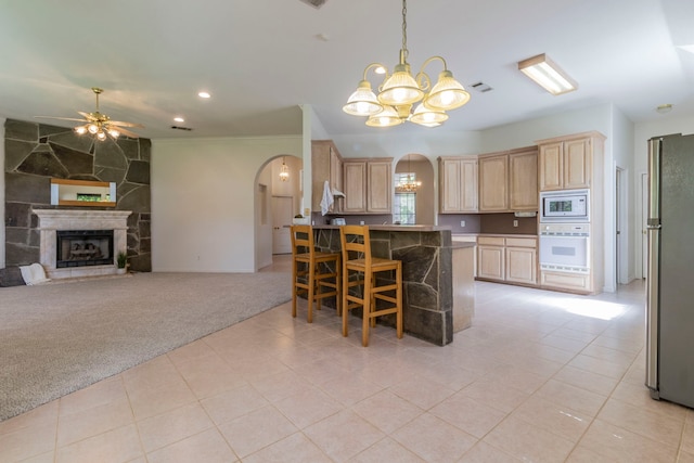 3528 Whitney Way, Hurst, TX 76054 - kitchen with white appliances, light brown cabinetry, arched walkways, light carpet, and recessed lighting