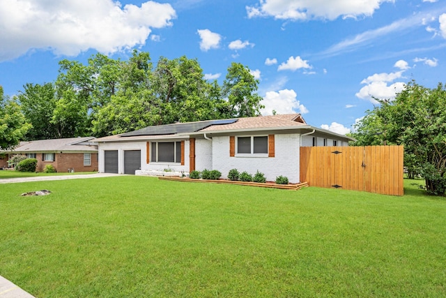 7017 Robinhood Ln, Fort Worth, TX 76112 - single story home featuring roof mounted solar panels, an attached garage, brick siding, and concrete driveway