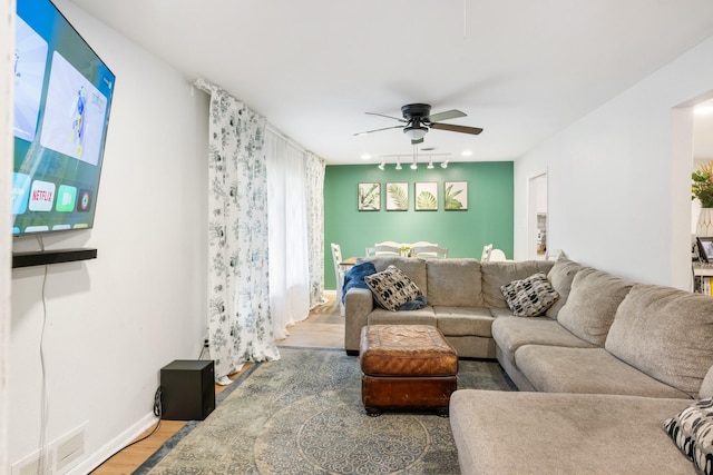 7017 Robinhood Ln, Fort Worth, TX 76112 - living area featuring light wood-style flooring, a ceiling fan, and baseboards