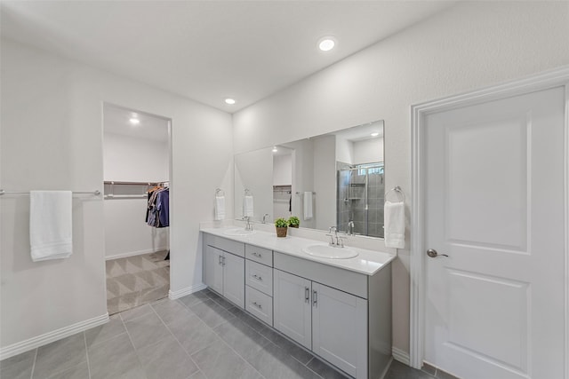 511 Rock Creek Dr, Princeton, TX 75407 - bathroom featuring double vanity, a walk in closet, a stall shower, baseboards, and recessed lighting