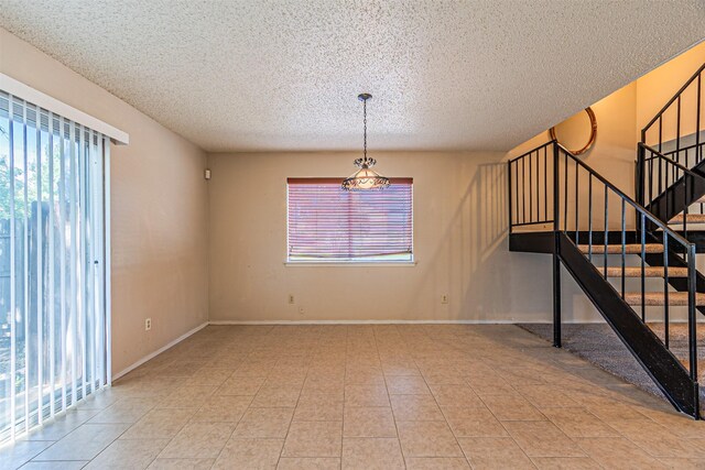 3626 Holly Tree Trl, Garland, TX 75044 - spare room with a textured ceiling, stairs, and baseboards