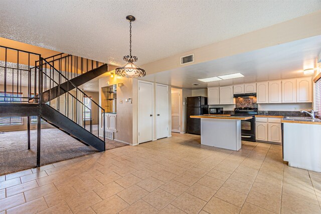 3626 Holly Tree Trl, Garland, TX 75044 - kitchen with black appliances, a sink, a kitchen island, pendant lighting, and white cabinetry