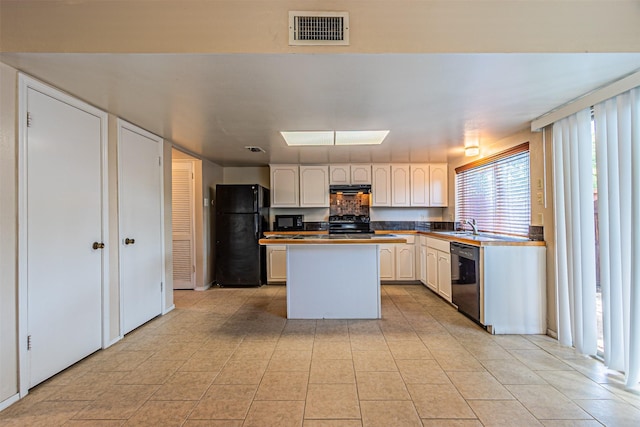 3626 Holly Tree Trl, Garland, TX 75044 - kitchen featuring black appliances, a center island, white cabinetry, a sink, and light tile patterned flooring