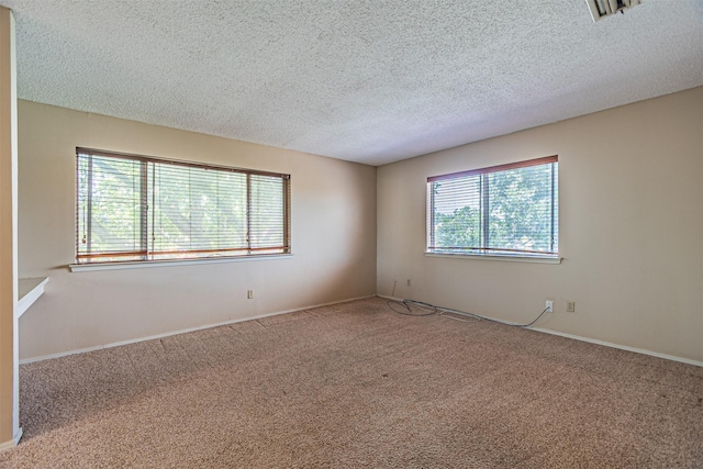 3626 Holly Tree Trl, Garland, TX 75044 - unfurnished room with carpet flooring, a textured ceiling, and baseboards