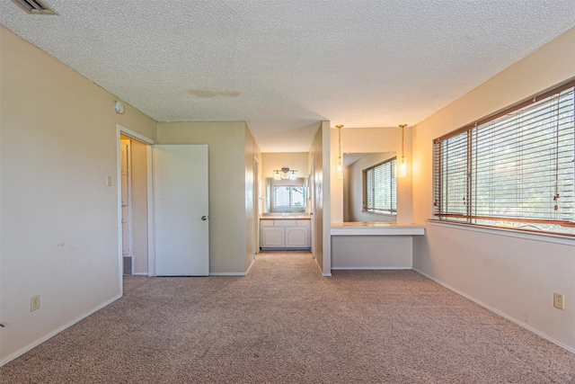 3626 Holly Tree Trl, Garland, TX 75044 - unfurnished bedroom with carpet flooring, a textured ceiling, baseboards, and ensuite bath