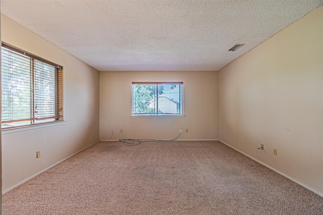 3626 Holly Tree Trl, Garland, TX 75044 - carpeted spare room featuring a textured ceiling and baseboards