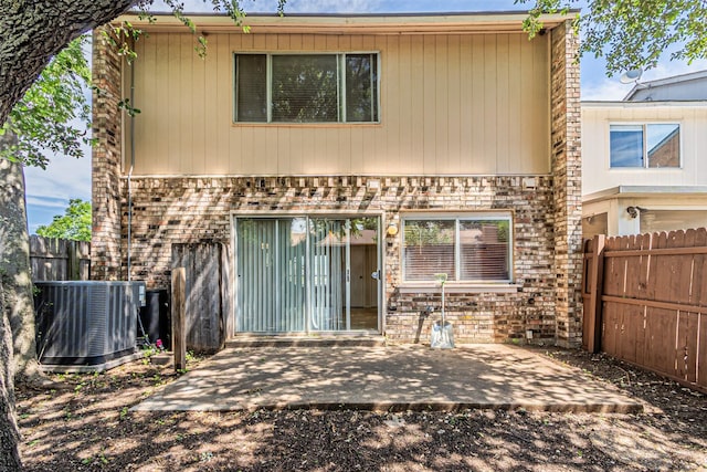 3626 Holly Tree Trl, Garland, TX 75044 - back of property featuring central AC unit, a patio, a fenced backyard, and brick siding