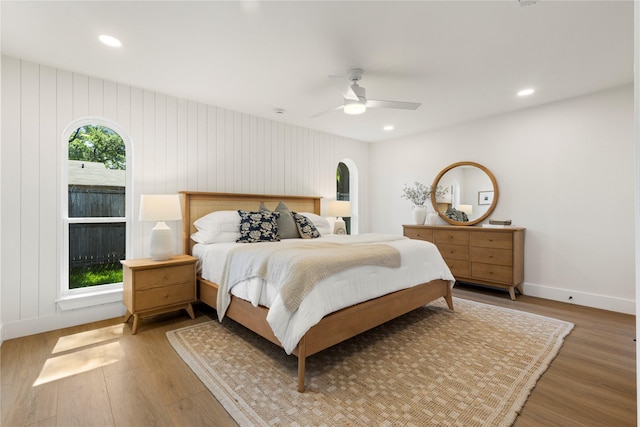 15616 Terrace Lawn Cir, Dallas, TX 75248 - bedroom with wood finished floors, recessed lighting, arched walkways, ceiling fan, and baseboards