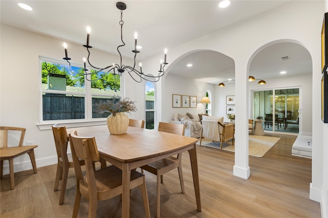 15616 Terrace Lawn Cir, Dallas, TX 75248 - dining room featuring arched walkways, recessed lighting, light wood finished floors, and healthy amount of natural light
