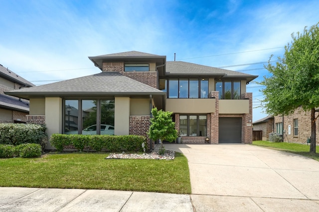 3711 Pistol Creek Dr, Frisco, TX 75034 - view of front of property featuring stucco siding, driveway, a front lawn, brick siding, and a garage