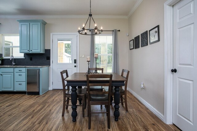 632 County Road 1952, Yantis, TX 75497 - dining room featuring a chandelier, dark wood-type flooring, crown molding, and baseboards