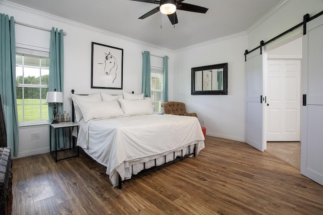 632 County Road 1952, Yantis, TX 75497 - bedroom with a barn door, ornamental molding, wood finished floors, baseboards, and ceiling fan