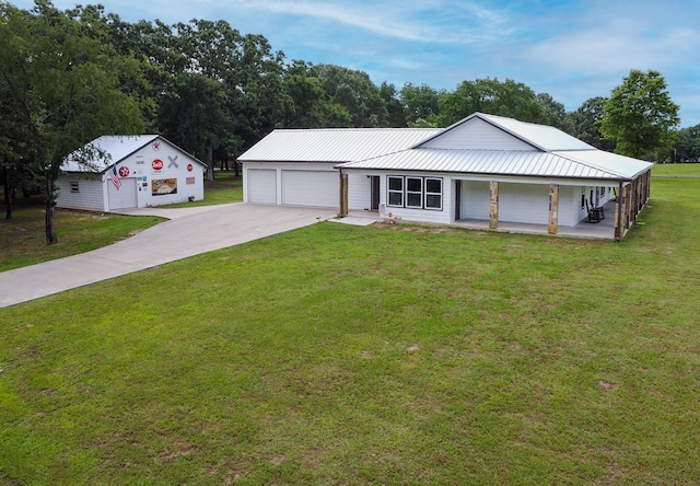 632 County Road 1952, Yantis, TX 75497 - view of front of home featuring a porch, a front lawn, concrete driveway, and metal roof