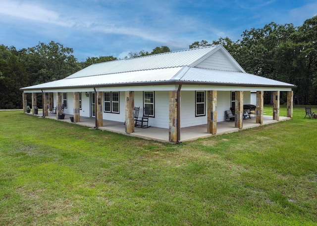 632 County Road 1952, Yantis, TX 75497 - back of property featuring metal roof, a yard, and covered porch