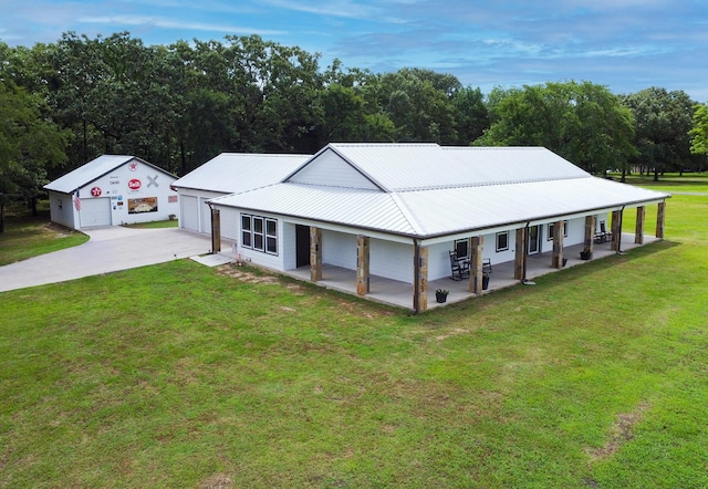 632 County Road 1952, Yantis, TX 75497 - farmhouse with a front yard, covered porch, driveway, metal roof, and a garage