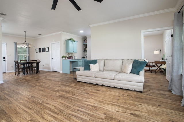 632 County Road 1952, Yantis, TX 75497 - living room featuring ceiling fan, crown molding, light wood-style flooring, a chandelier, and baseboards