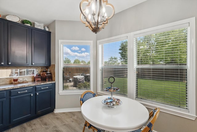 2304 Ranch House Dr, Denton, TX 76210 - dining space with a chandelier, light wood-style flooring, and baseboards
